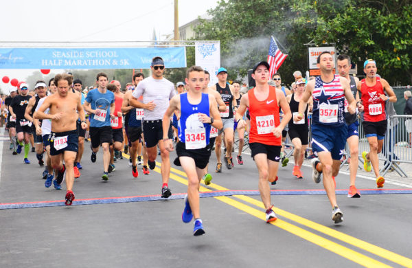 Runners crossing finish line of the Seaside Half Marathon